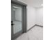 Hallway featuring a glass windowed door, grey trim, and marble floors at 211 22Nd Street Ne Ct, Bradenton, FL 34208