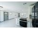 Open concept kitchen featuring white cabinets, modern appliances, and bright countertops and marble floors at 211 22Nd Street Ne Ct, Bradenton, FL 34208