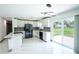 Modern kitchen with white cabinets, stainless steel appliances, stylish backsplash and plenty of counter space at 211 22Nd Street Ne Ct, Bradenton, FL 34208