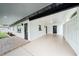 Covered patio features painted concrete floors, black trim, and access to multiple entrances at 211 22Nd Street Ne Ct, Bradenton, FL 34208