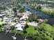 Aerial view showcasing the modern home's location near a river, surrounded by lush greenery and other residences at 2110 Michele Dr, Sarasota, FL 34231