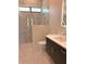 Modern bathroom featuring a walk-in shower and dark wood vanity at 2110 Michele Dr, Sarasota, FL 34231