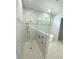 Sleek, tiled walk-in shower with glass partition and modern fixtures in a bright, well-lit bathroom at 2110 Michele Dr, Sarasota, FL 34231