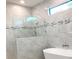 Luxurious bathroom showcasing a modern soaking tub and stylish white marble tiling throughout at 2110 Michele Dr, Sarasota, FL 34231
