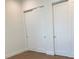Bedroom with two closets featuring sliding doors at 2110 Michele Dr, Sarasota, FL 34231
