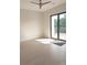 Bright bedroom features hardwood floors, ceiling fan and sliding doors to the backyard at 2110 Michele Dr, Sarasota, FL 34231