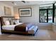 Well-lit bedroom with a large window, hardwood floors, and modern decor at 2110 Michele Dr, Sarasota, FL 34231