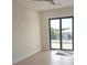 Bright bedroom features hardwood floors, ceiling fan and sliding doors to the backyard at 2110 Michele Dr, Sarasota, FL 34231