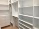 Spacious walk-in closet designed with custom shelving and drawers for optimal organization at 2110 Michele Dr, Sarasota, FL 34231