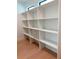 Custom closet with extensive shelving, wood floors and recessed lighting at 2110 Michele Dr, Sarasota, FL 34231