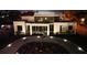 Night view highlighting modern home with circular driveway and landscaped entrance, creating a welcoming ambiance at 2110 Michele Dr, Sarasota, FL 34231