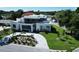 Stunning contemporary home featuring a modern design, lush landscaping, and a circular driveway at 2110 Michele Dr, Sarasota, FL 34231
