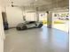 Spacious garage with speckled flooring containing a new sports car at 2110 Michele Dr, Sarasota, FL 34231