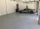 Spacious garage with speckled flooring containing a new sports car at 2110 Michele Dr, Sarasota, FL 34231