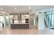 Spacious kitchen with stainless steel appliances, large island, and modern lighting fixtures at 2110 Michele Dr, Sarasota, FL 34231