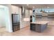 Open kitchen layout featuring stainless steel appliances, a large island, and modern pendant lighting at 2110 Michele Dr, Sarasota, FL 34231