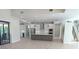 Open kitchen features stainless appliances, pendant lights, and a large central island, perfect for entertaining at 2110 Michele Dr, Sarasota, FL 34231
