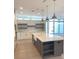 Spacious kitchen features an oversized island with a sink and stainless steel pendant lighting at 2110 Michele Dr, Sarasota, FL 34231