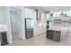 View of stainless fridge, white cabinets and center island at 2110 Michele Dr, Sarasota, FL 34231