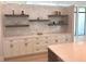 Modern kitchen with white cabinets, floating shelves, mosaic backsplash and light countertops at 2110 Michele Dr, Sarasota, FL 34231