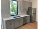 Modern kitchen featuring stainless steel appliances, light gray cabinetry, white countertops and stylish backsplash at 2110 Michele Dr, Sarasota, FL 34231
