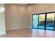 Bright living room with hardwood floors and sliding glass doors leading to the outdoors at 2110 Michele Dr, Sarasota, FL 34231