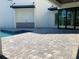 Modern outdoor kitchen and covered patio area with a stone paver patio at 2110 Michele Dr, Sarasota, FL 34231