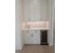 Stylish wet bar area featuring a wine cooler, tiled backsplash and custom cabinetry at 2110 Michele Dr, Sarasota, FL 34231