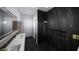 Elegant bathroom featuring dark marble tile, gold fixtures, and a walk-in shower at 2221 Wood St, Sarasota, FL 34237