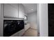 Well-organized laundry room with modern appliances, cabinets, and sink at 2221 Wood St, Sarasota, FL 34237
