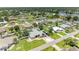 Aerial view of neighborhood featuring houses, green lawns and mature trees at 23136 Langdon Ave, Port Charlotte, FL 33954