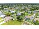 Overhead shot of residential neighborhood featuring houses, green lawns, and mature trees at 23136 Langdon Ave, Port Charlotte, FL 33954