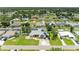 Real estate listing image showcases house with green lawn, solar panels, and mature trees at 23136 Langdon Ave, Port Charlotte, FL 33954