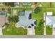 Aerial view of home featuring a swimming pool, solar panels, and well-maintained landscaping at 23136 Langdon Ave, Port Charlotte, FL 33954