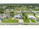 Real estate listing image showcases house with pool, solar panels, green lawn and mature trees at 23136 Langdon Ave, Port Charlotte, FL 33954