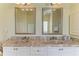 Bathroom with double sinks, marble countertops, and decorative mirrors, combining functionality with elegance at 23136 Langdon Ave, Port Charlotte, FL 33954