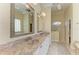 Spacious bathroom with double sinks, marble countertops, and a shower, offering a luxurious and functional space at 23136 Langdon Ave, Port Charlotte, FL 33954