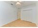 Bedroom featuring laminate floors, and a closet with bi-fold doors at 23136 Langdon Ave, Port Charlotte, FL 33954