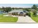 Inviting single Gathering home featuring a well-manicured lawn, solar panels, and a spacious driveway at 23136 Langdon Ave, Port Charlotte, FL 33954