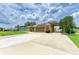 Lovely home with an extended driveway, well-maintained lawn, and solar panels at 23136 Langdon Ave, Port Charlotte, FL 33954