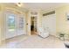 Bright foyer with tile flooring, a white leather chair, and decorative glass doors at 23136 Langdon Ave, Port Charlotte, FL 33954