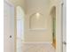 Open hallway featuring arched architectural details and natural light at 23136 Langdon Ave, Port Charlotte, FL 33954