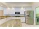 Modern kitchen featuring stainless steel appliances, granite countertops, and ample storage space at 23136 Langdon Ave, Port Charlotte, FL 33954