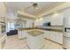 Open kitchen featuring a central island, granite countertops, stainless appliances and tile flooring at 23136 Langdon Ave, Port Charlotte, FL 33954