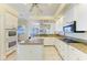 Open kitchen featuring granite counters, stainless appliances and an island with breakfast bar at 23136 Langdon Ave, Port Charlotte, FL 33954