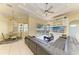 Spacious living room with ceiling fan, built-in shelving, and views of the pool area at 23136 Langdon Ave, Port Charlotte, FL 33954