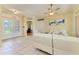 An open concept living room featuring tile floors, white leather couches and light yellow walls at 23136 Langdon Ave, Port Charlotte, FL 33954