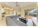 Open-concept living room leading to the patio with pool access and access to the kitchen at 23136 Langdon Ave, Port Charlotte, FL 33954