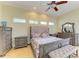 Well-lit bedroom with hardwood floors, a ceiling fan, and stylish gray furniture, creating a comfortable and inviting space at 23136 Langdon Ave, Port Charlotte, FL 33954