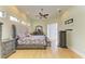 Bright bedroom featuring hardwood floors, a ceiling fan, access to the lanai and a tastefully designed grey upholstered bed at 23136 Langdon Ave, Port Charlotte, FL 33954